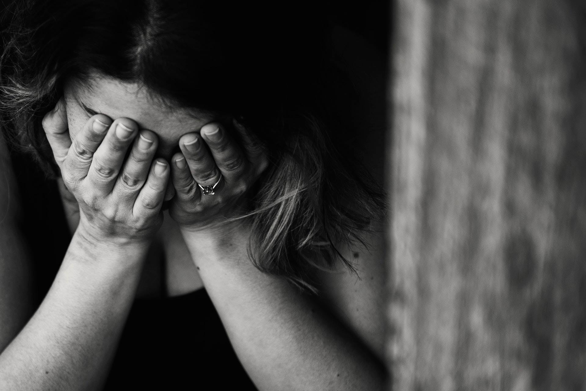 Lady Covering Face with Hands